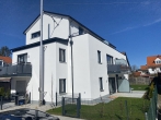 Neubau EBZ: attraktive Gartenwohnung mit Süd-West Garten und Terrasse in bester Lage in Karlsfeld! - Hausansicht